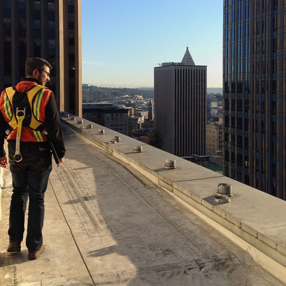 harnessed man on roof